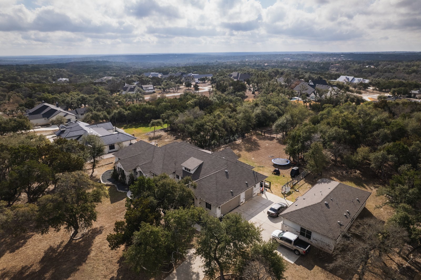 Completed shingle roof replacement with Hill Country horizon